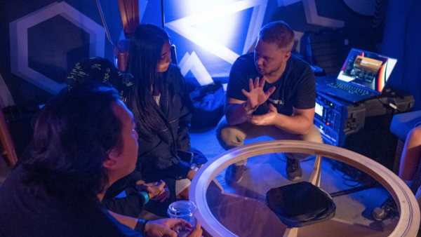 CEO of Edgesound Research Valtteri Salomaki explaining his sound technology to 3 peple in a sound studio.