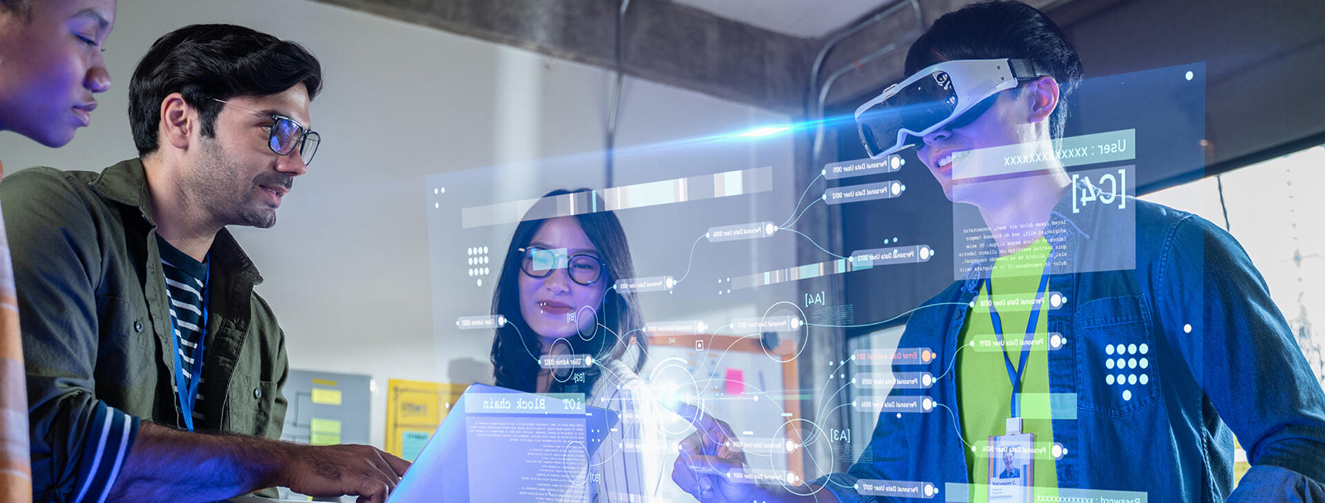 Innovative researchers in a high-tech room testing AI technology. One of the researchers is wearing a headset over their eyes and there is a projection screen showing the programming screen he is looking at.